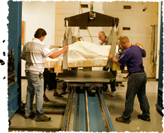 Image: Scientists and technicians load the fossil block onto the giant scanner.